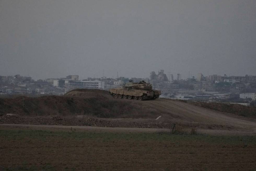 An Israeli tank overlooks the Gaza Strip, as seen from southern Israel, Wednesday, Sept. 11, 20 ...