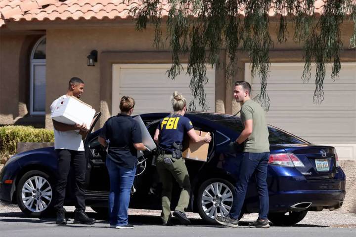 FILE - FBI personnel remove boxes and computers from a home on the corner of West La Madre Way ...