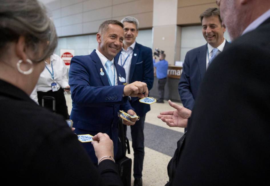 Norse Atlantic Airways staff hand out keychains and pins during the celebration of airways&#x20 ...