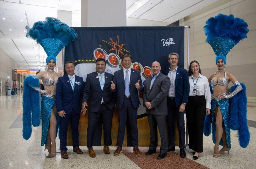 Norse Atlantic Airways staff take photographs with showgirls during the celebration of the airw ...