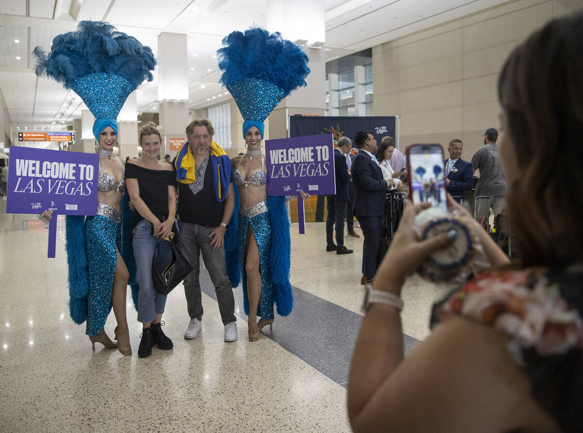 Travelers poses for photographs with showgirls during the celebration of Norse Atlantic Airways ...