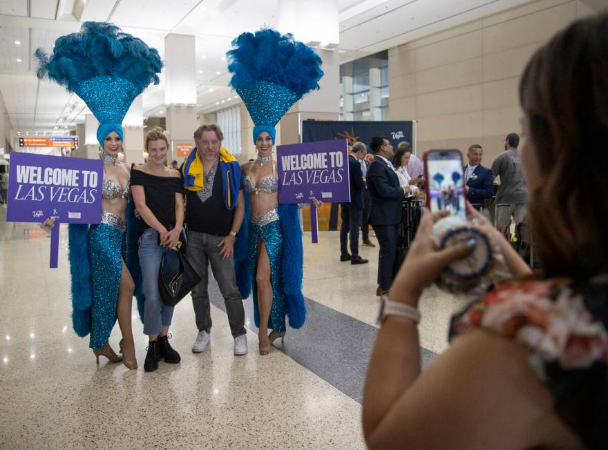 Travelers poses for photographs with showgirls during the celebration of Norse Atlantic Airways ...