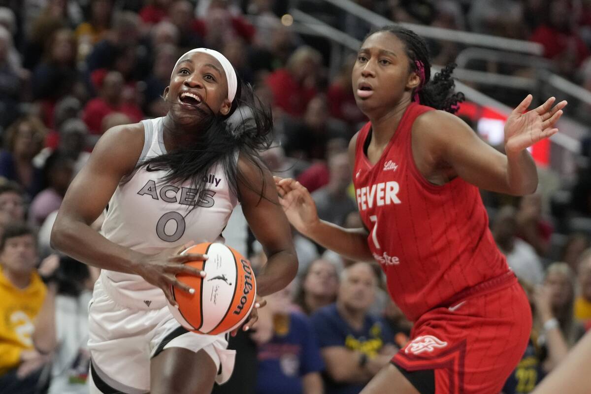 Las Vegas Aces' Jackie Young (0) goes to the basket against Indiana Fever's Aliyah Boston durin ...