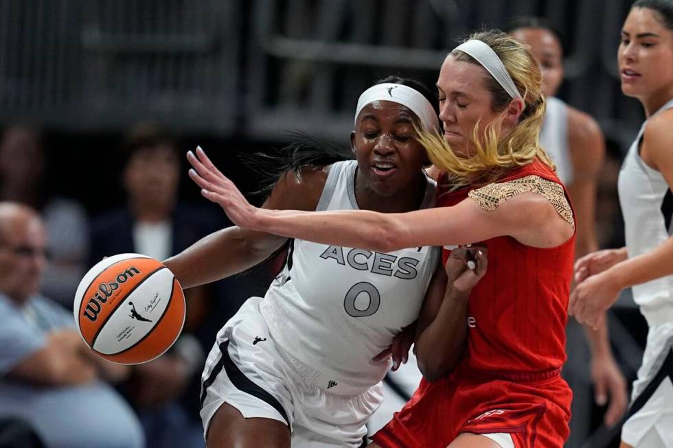 Las Vegas Aces' Jackie Young (0) is defended by Indiana Fever's Lexie Hull during the first hal ...