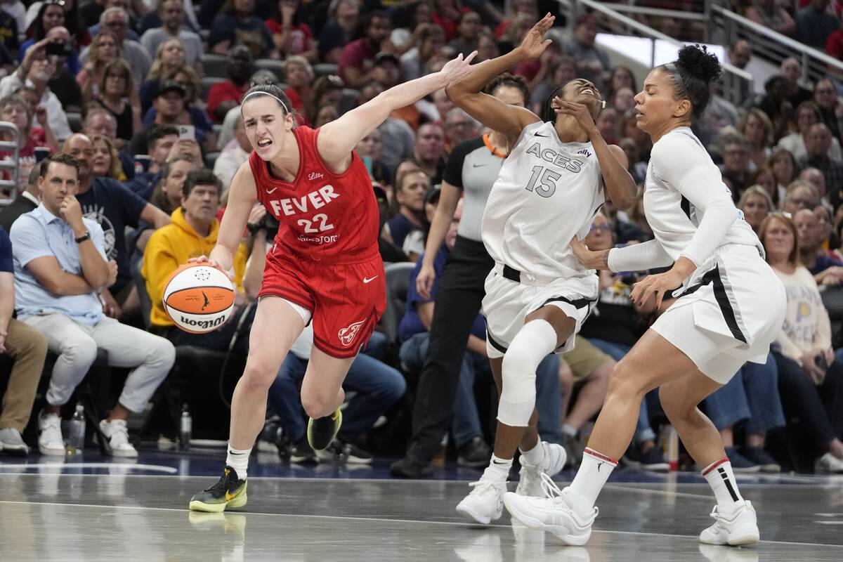 Indiana Fever's Caitlin Clark (22) is called for a foul against Las Vegas Aces' Tiffany Hayes ( ...