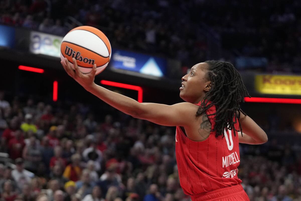 Indiana Fever's Kelsey Mitchell puts up a shot during the first half of a WNBA basketball game ...