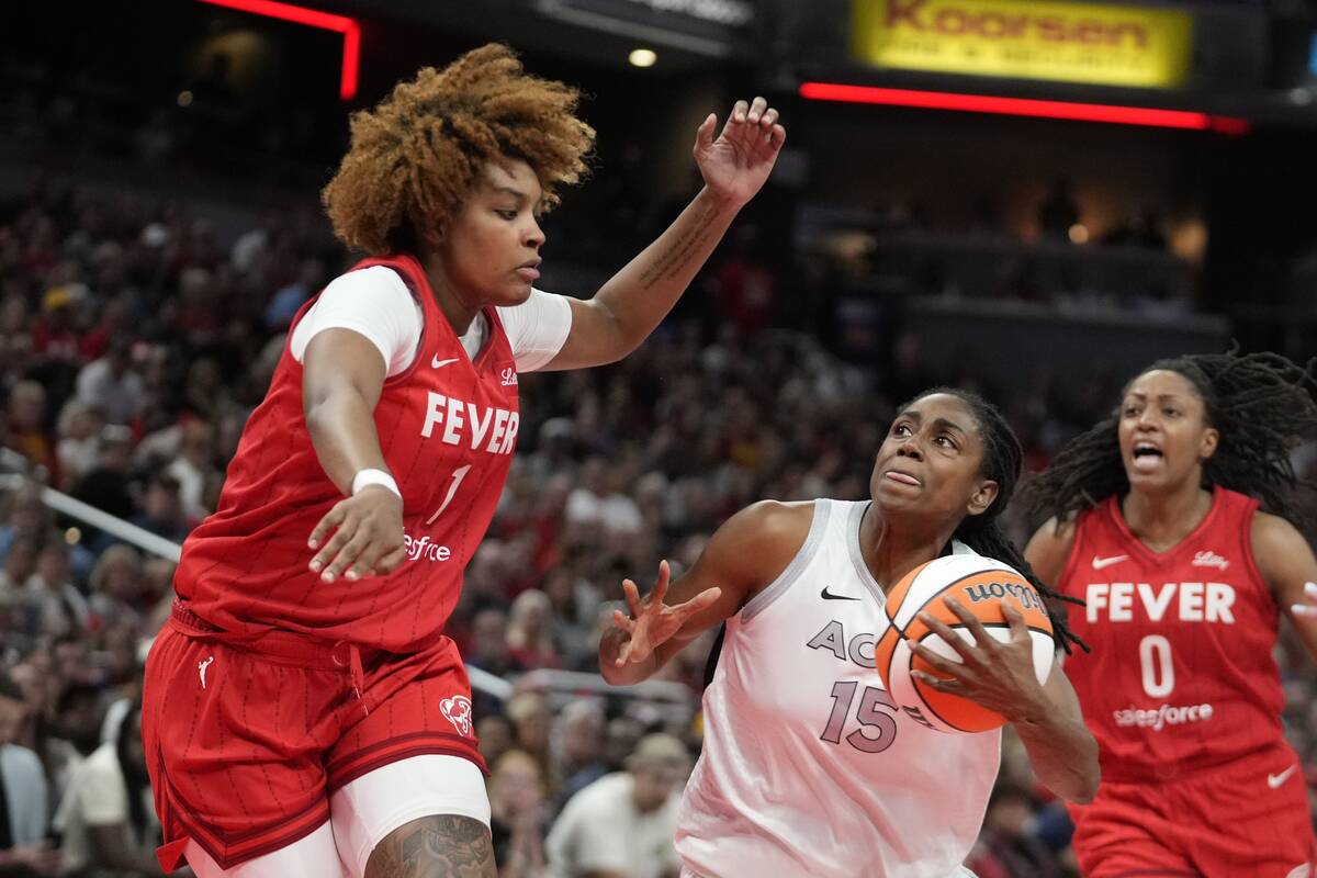 Las Vegas Aces' Tiffany Hayes (15 goes to the basket against Indiana Fever's NaLyssa Smith (1) ...