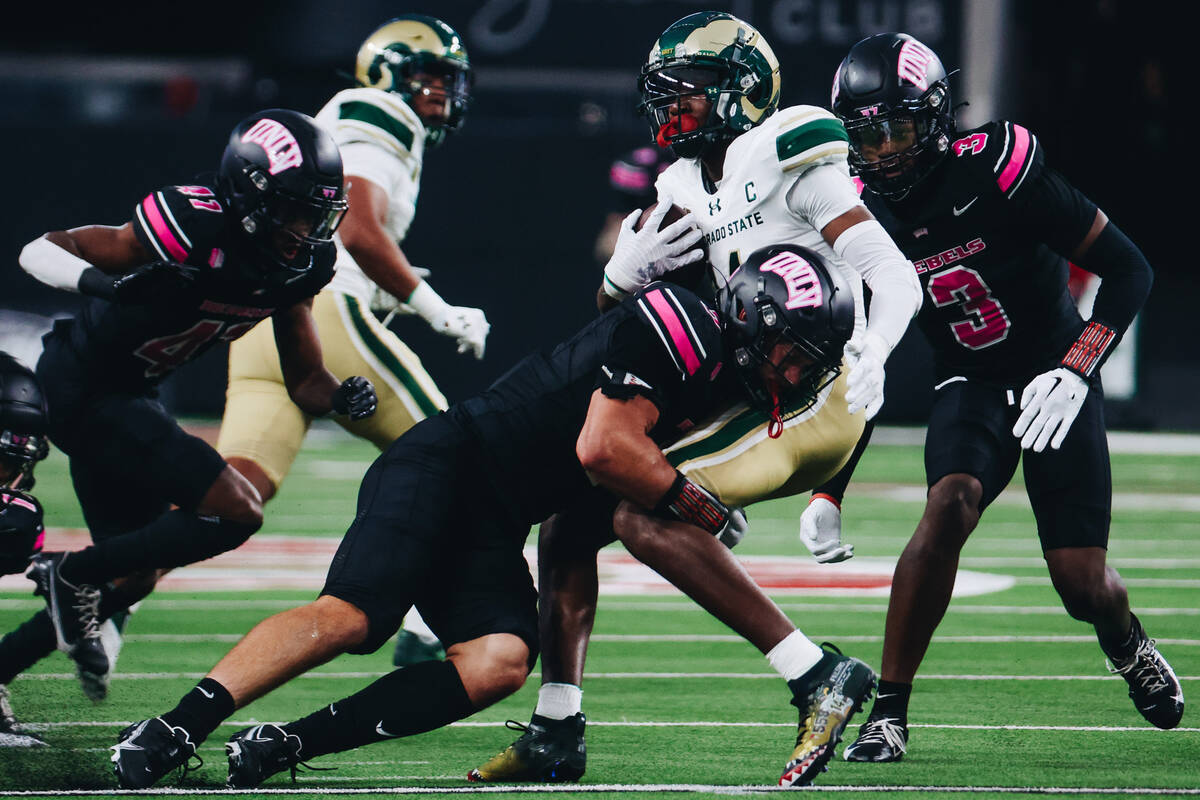 Colorado State wide receiver Tory Horton (14) gets taken down with the ball by a pack of UNLV d ...