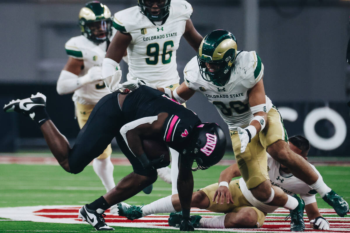 UNLV running back Donavyn Lester (4) falls with the ball during a game against Colorado State a ...