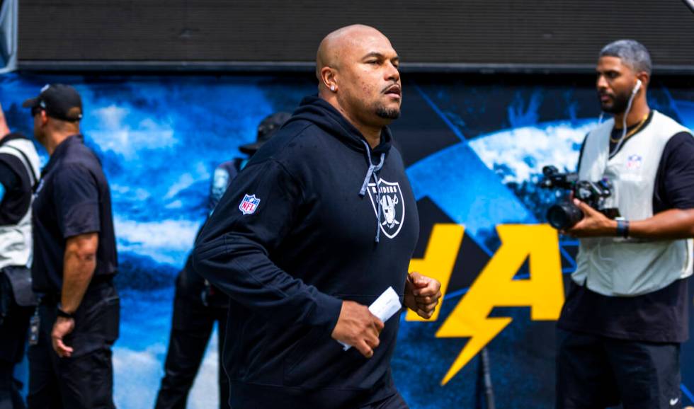 Raiders head coach Antonio Pierce runs out of the tunnel to face the Los Angeles Chargers for t ...