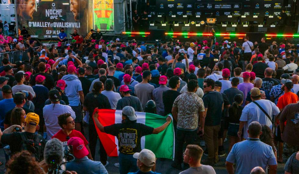 A fan holds a Mexican flag UFC 306 press conference at the Sphere on Thursday, Sept. 12, 2024, ...