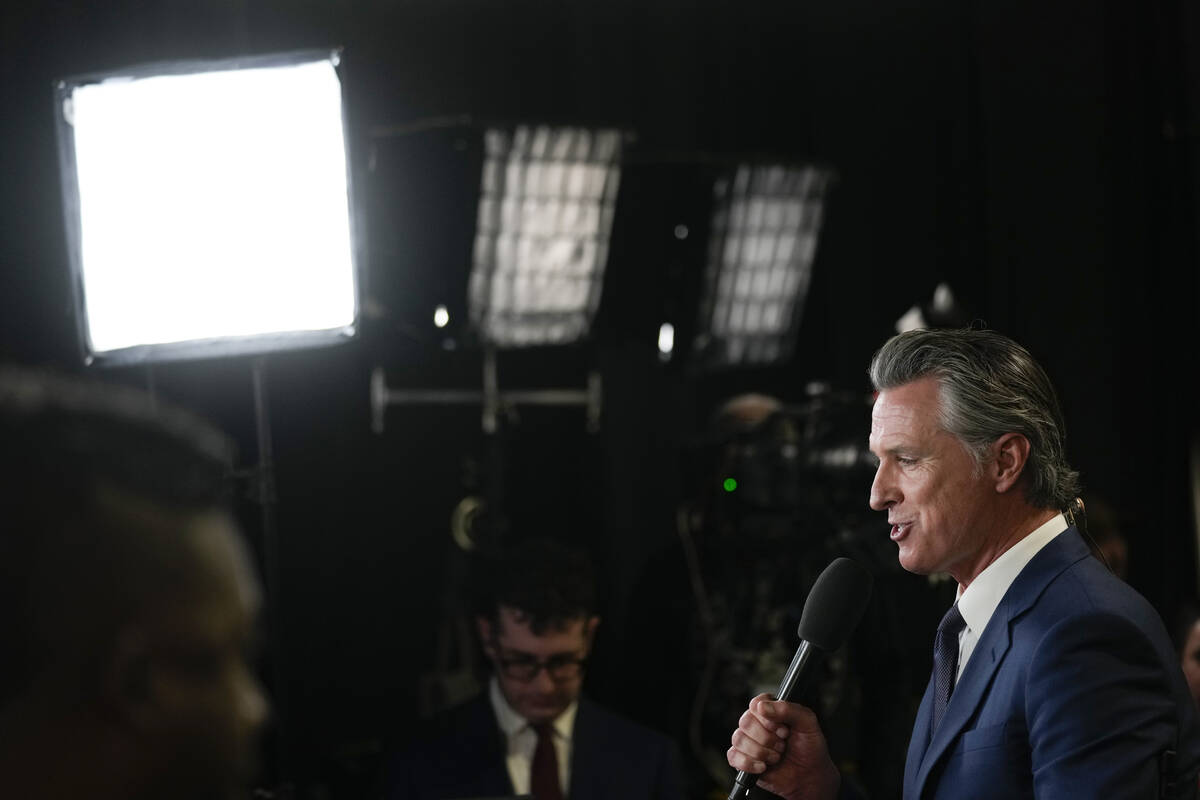 California Gov. Gavin Newsom speaks to reporters in the spin room before a presidential debate ...