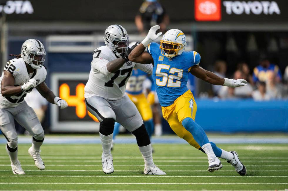 Los Angeles Chargers linebacker Khalil Mack (52) runs past Las Vegas Raiders offensive tackle T ...