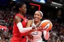 Las Vegas Aces' A'ja Wilson (22) goes to the basket against Indiana Fever's Temi Fagbenle (14) ...