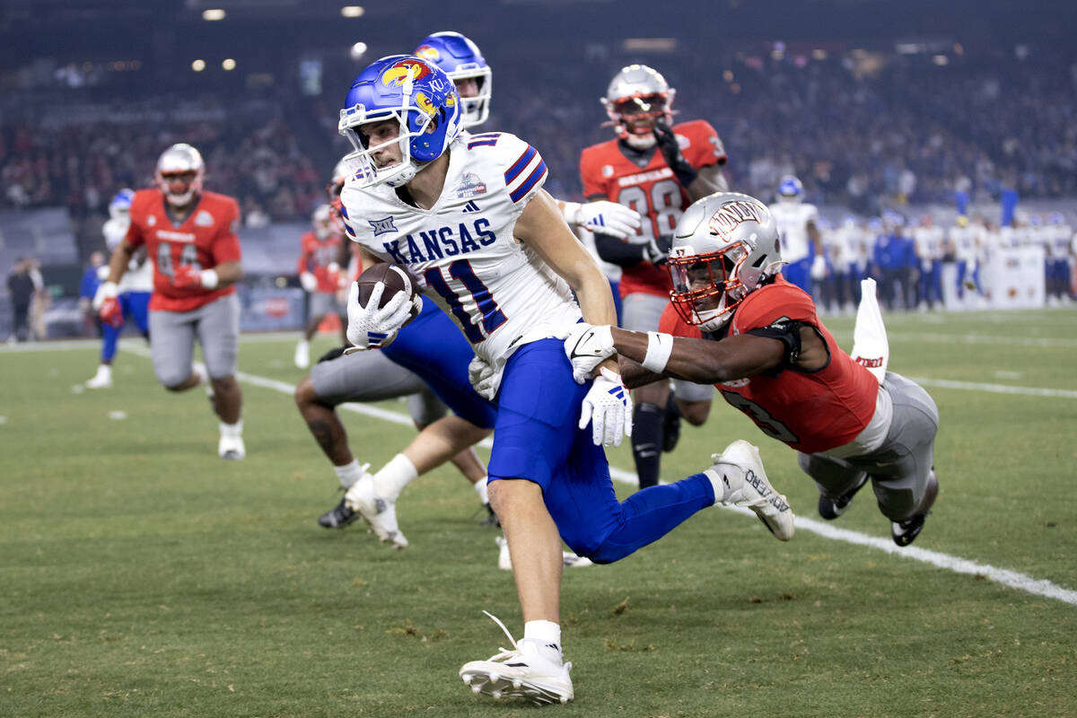 UNLV Rebels defensive back Johnathan Baldwin (3) attempts to tackle Kansas Jayhawks wide receiv ...