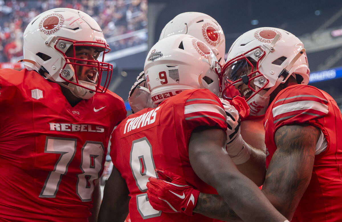 UNLV players celebrate after running back Jai'Den Thomas (9) scores a touchdown during the coll ...