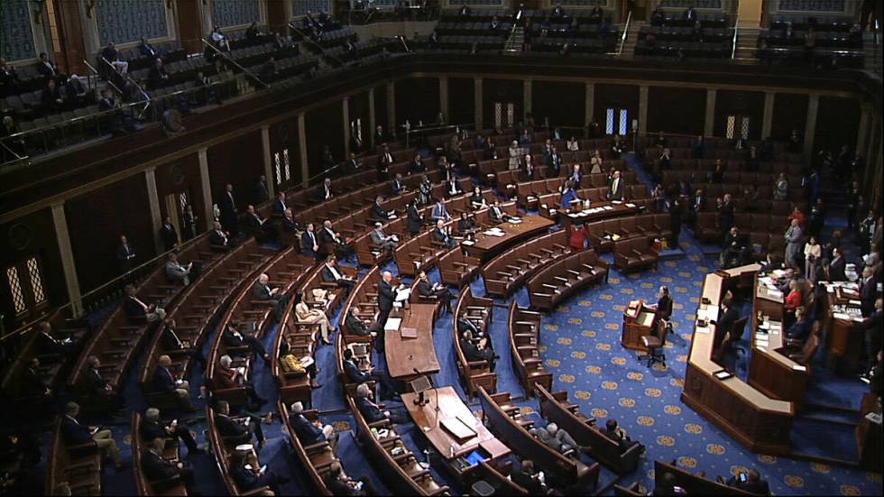 In this image from video, members of the House practice social distancing as they sit on the fl ...