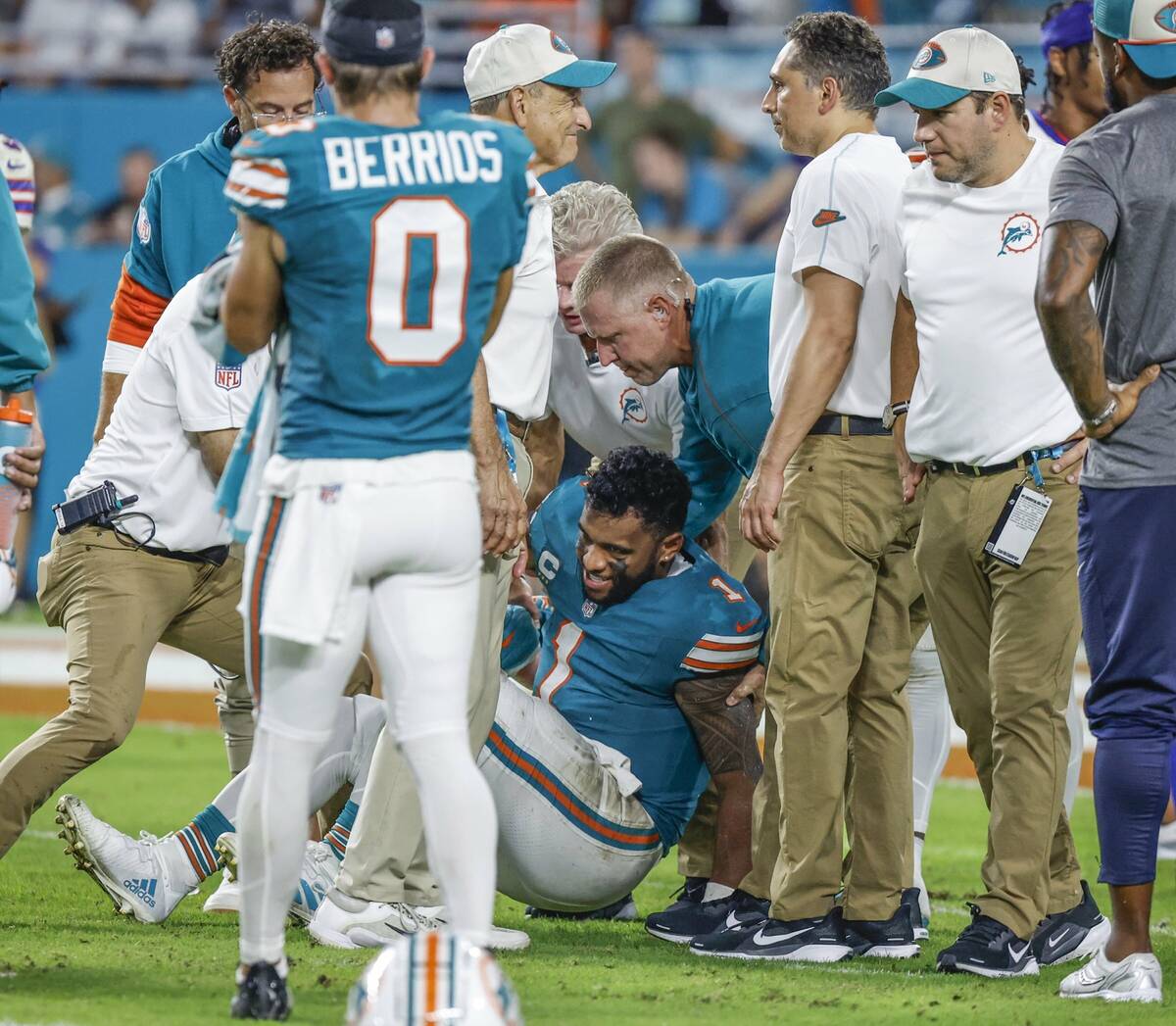 Miami Dolphins quarterback Tua Tagovailoa (1) is assisted after an injury in the third quarter ...