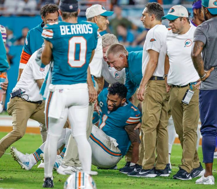 Miami Dolphins quarterback Tua Tagovailoa (1) is assisted after an injury in the third quarter ...