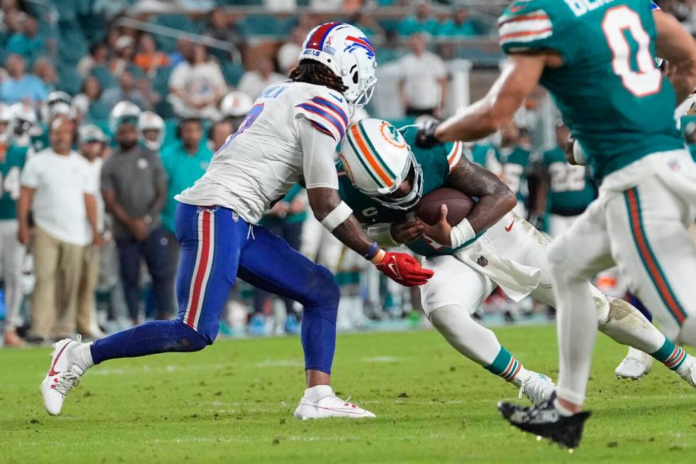 Miami Dolphins quarterback Tua Tagovailoa (1) and Buffalo Bills safety Damar Hamlin (3) collide ...