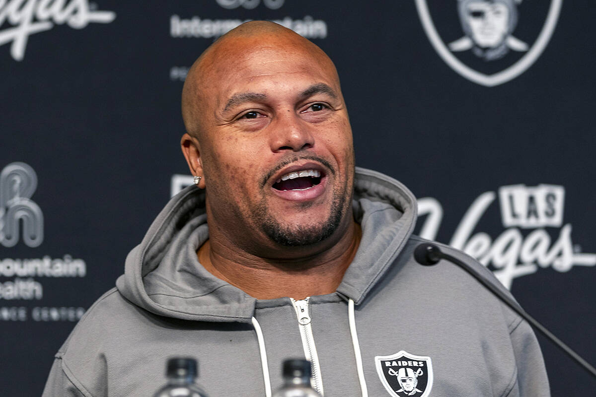 Raiders head coach Antonio Pierce answers a question during a media interview before practice a ...