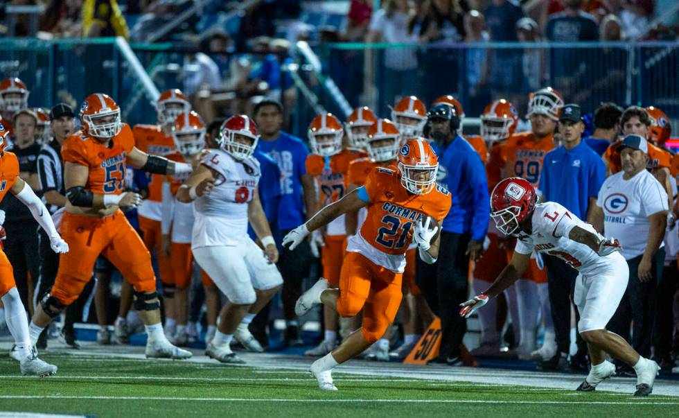 Bishop Gorman running back Jonathan Coar (21) cuts up field to evade Orange Lutheran defensive ...