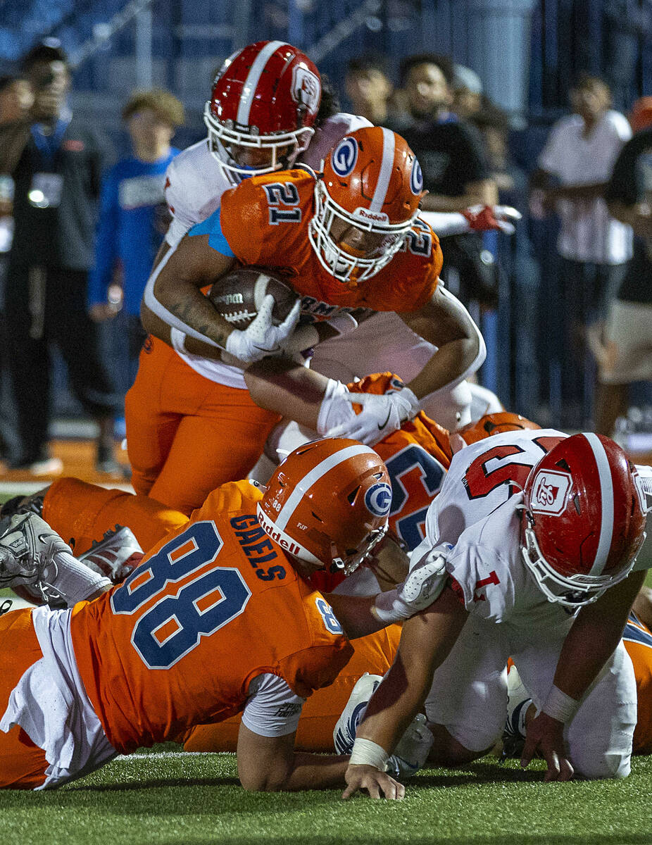 Bishop Gorman running back Jonathan Coar (21) battles for yards near the end zone against Orang ...