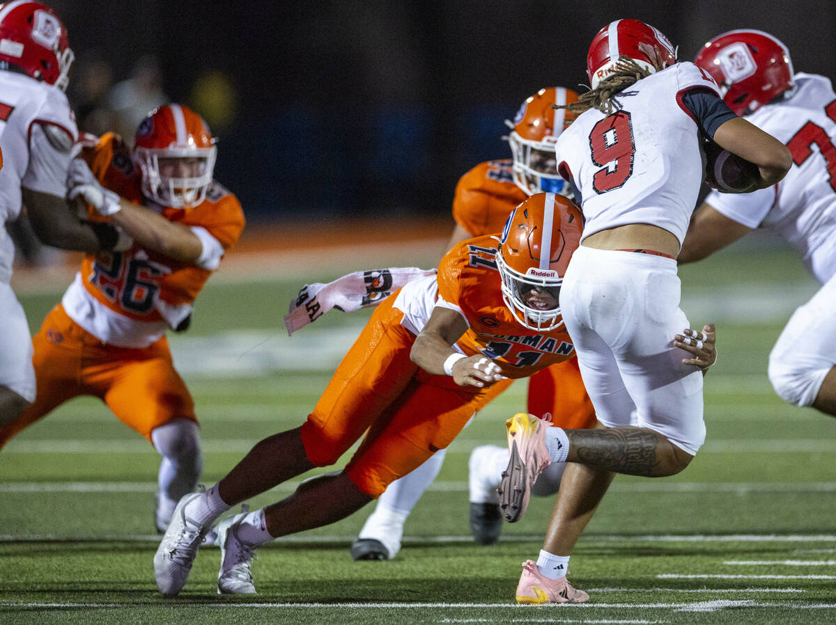 Bishop Gorman linebacker Tamatoa Gaoteote (11) stops a run by Orange Lutheran quarterback Tj La ...