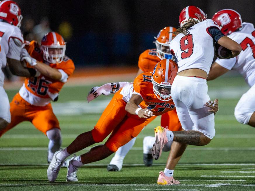 Bishop Gorman linebacker Tamatoa Gaoteote (11) stops a run by Orange Lutheran quarterback Tj La ...