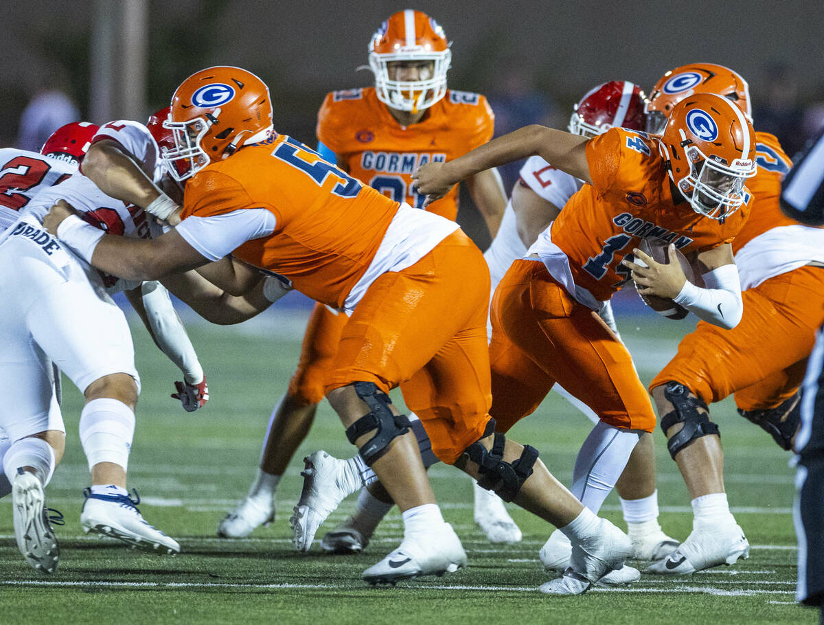 Bishop Gorman quarterback Maika Eugenio (14) breaks through the line on a run against Orange Lu ...