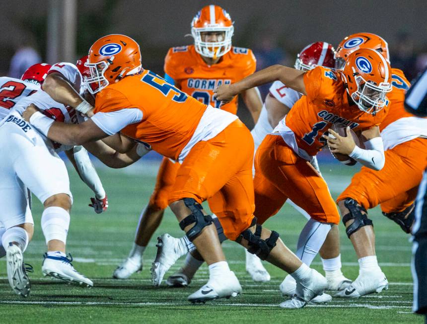 Bishop Gorman quarterback Maika Eugenio (14) breaks through the line on a run against Orange Lu ...