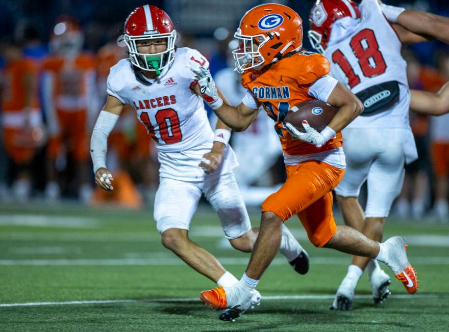 Bishop Gorman running back Myles Norman (24) looks to turn the corner on Orange Lutheran defens ...