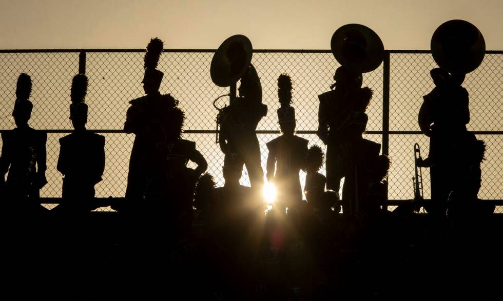 Shadow Ridge Thundering Herd marching band members wait to play in the stands during the high s ...