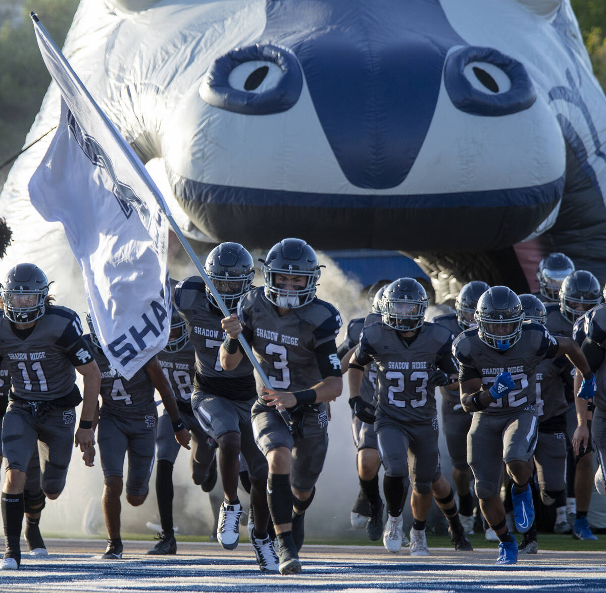 Shadow Ridge quarterback Ula Cox (3) leads the team out onto the field before the high school f ...