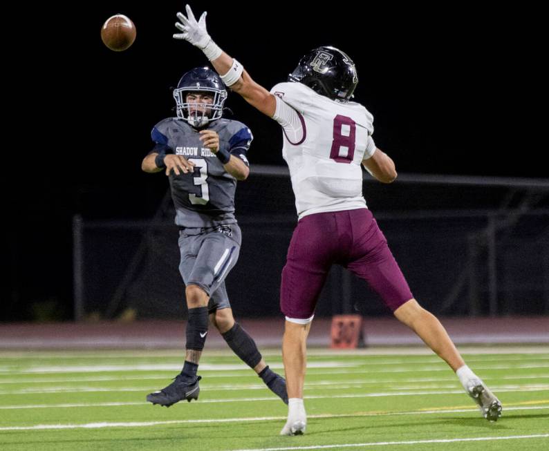 Faith Lutheran senior Cole Keith (8) attempts to block Shadow Ridge quarterback Ula Cox (3) dur ...