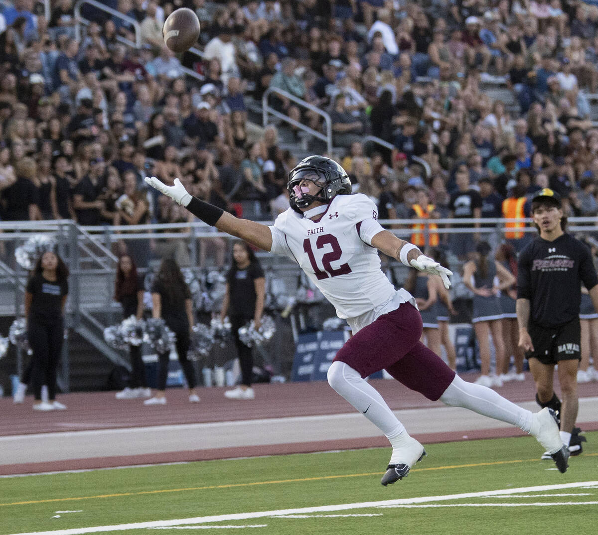 Faith Lutheran junior Aipa Kuloloia (12) dives for a pass that is out of reach during the high ...