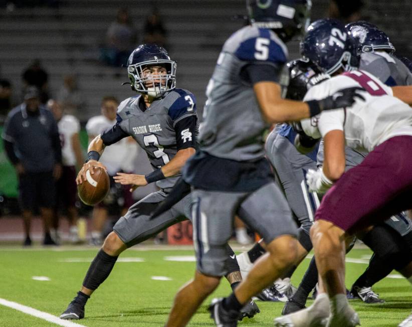 Shadow Ridge quarterback Ula Cox (3) looks to throw the ball during the high school football ga ...