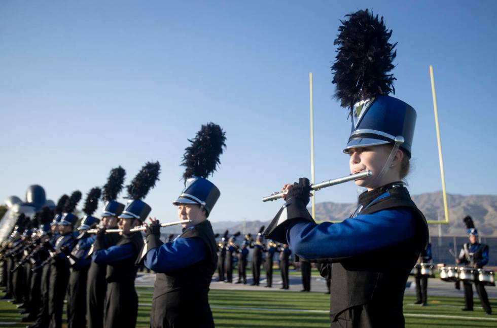 Shadow Ridge Thundering Herd marching band members play the fight song before the high school f ...