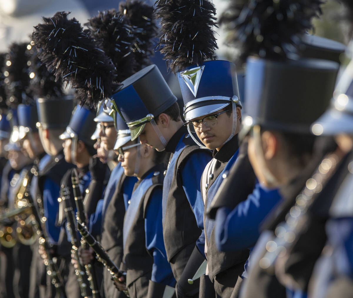 Shadow Ridge Thundering Herd marching band members create a tunnel before the high school footb ...