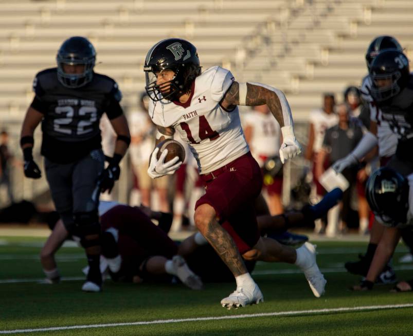 Faith Lutheran senior Cale Breslin (14) runs the ball for a touchdown during the high school fo ...