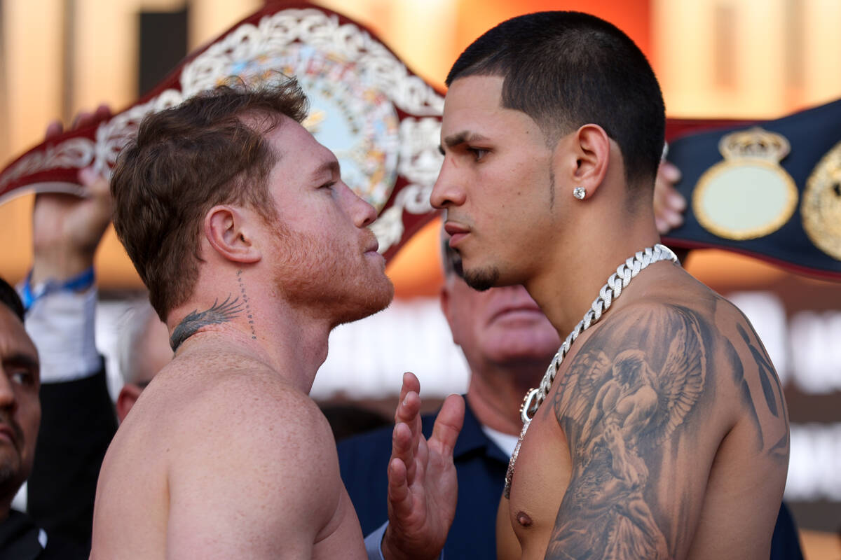 Canelo Alvarez, left, and Edgar Berlanga, right, face off during weigh ins ahead of their super ...