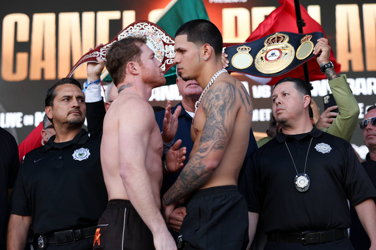 Canelo Alvarez, left, and Edgar Berlanga, right, face off during weigh ins ahead of their super ...