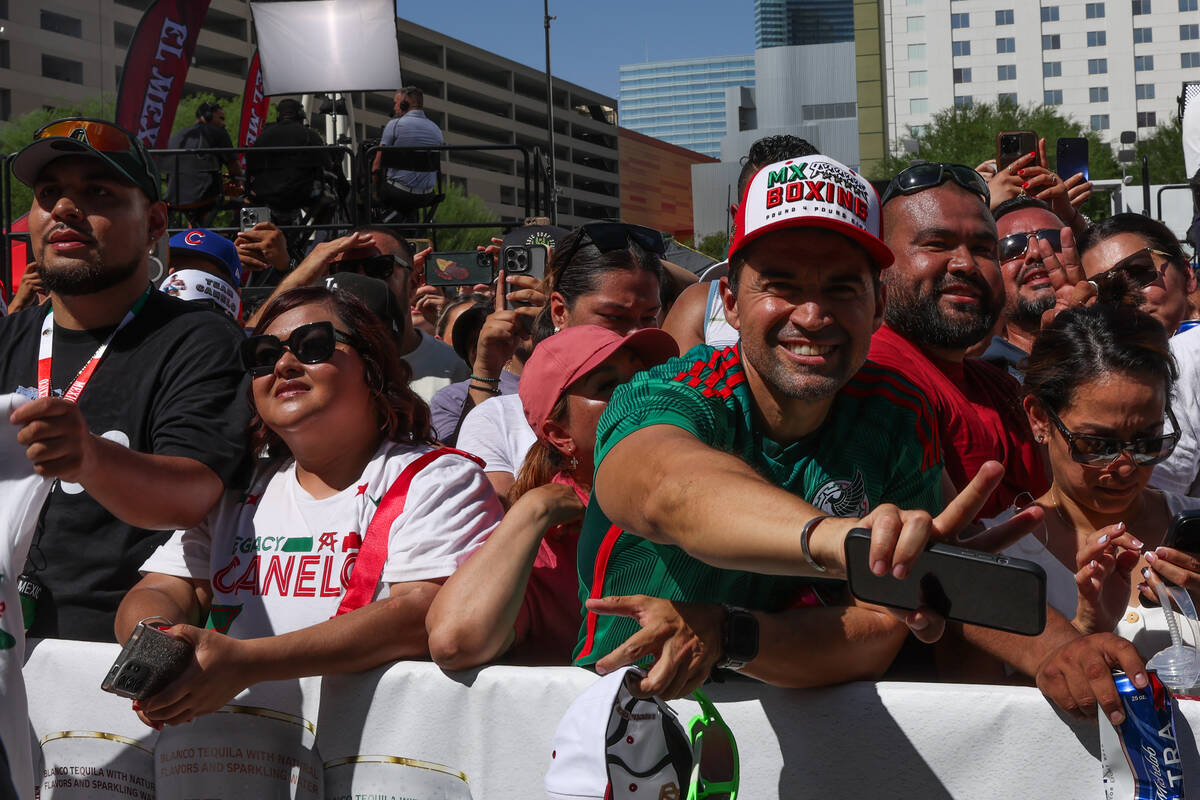 Fans cheer for their fighters during weigh ins ahead of a super middleweight title boxing bout ...