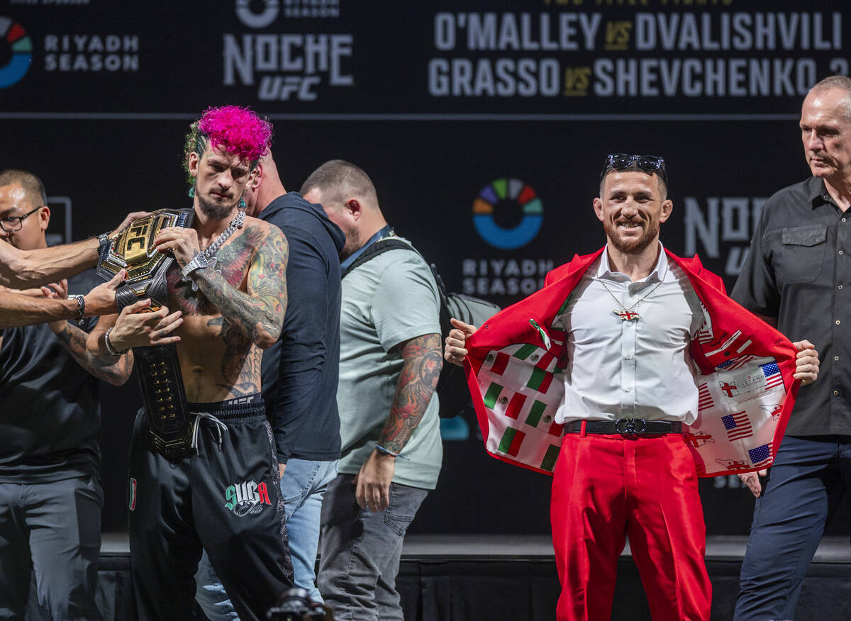 Fighters Sean O'Malley, left, and Merab Dvalishvili pose after their face off for their Bantamw ...