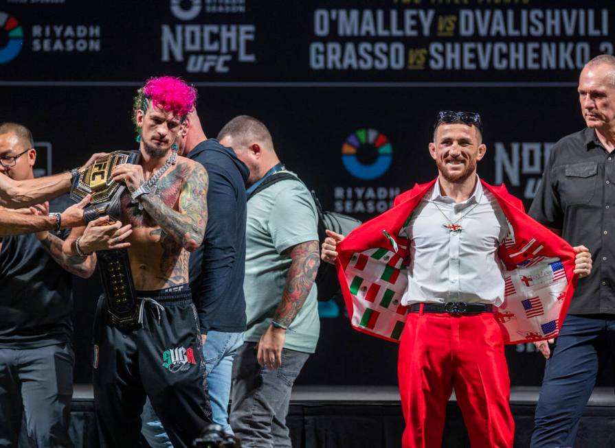 Fighters Sean O'Malley, left, and Merab Dvalishvili pose after their face off for their Bantamw ...