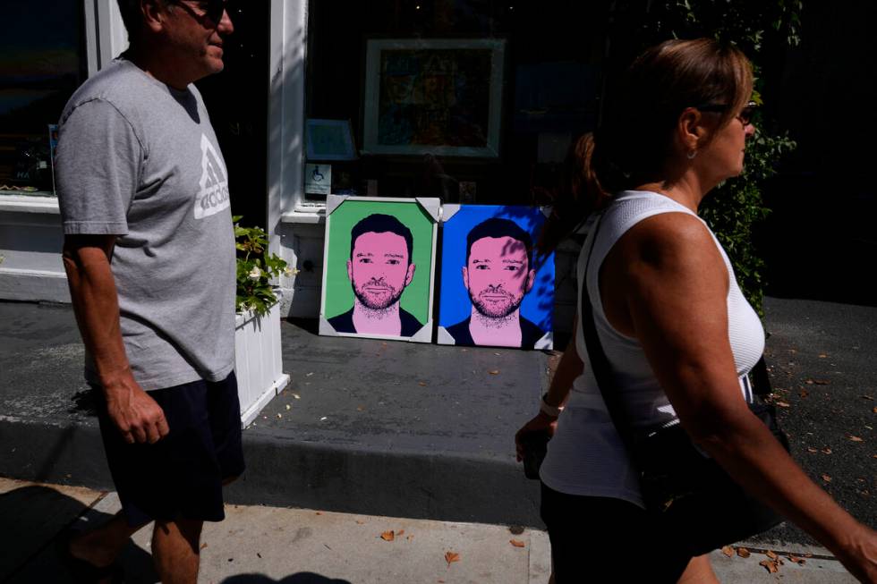 People walk past paintings of Justin Timberlake outside a gallery, Friday, Sept. 13, 2024, in S ...