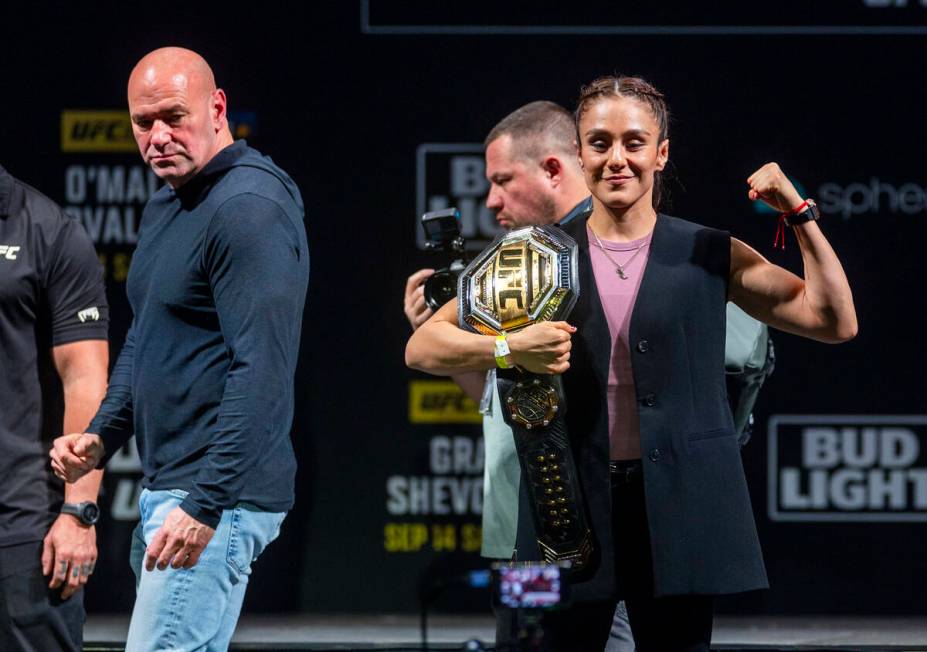 Fighter Alexa Grasso poses with her belt as UFC president Dana White looks on after her face-of ...