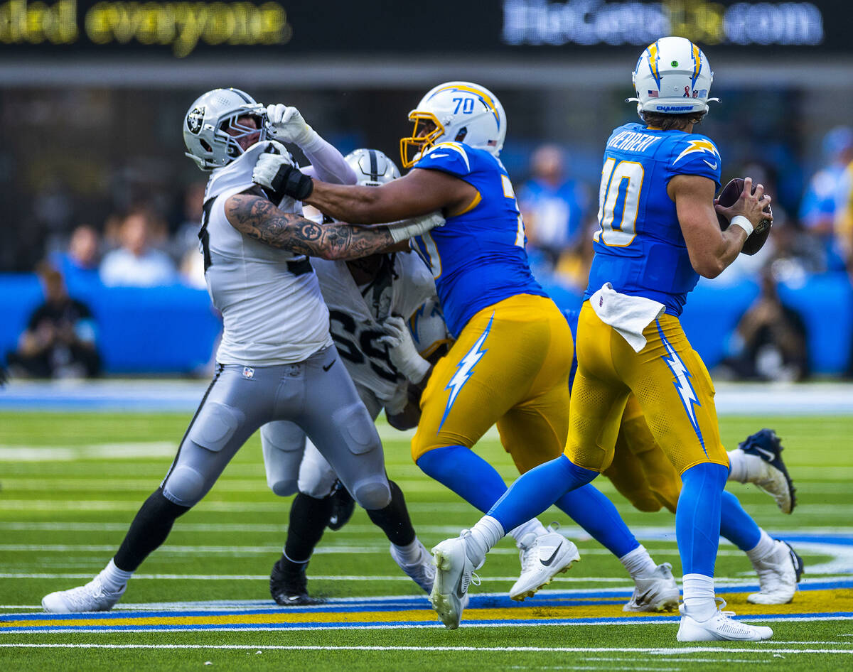 Raiders defensive end Maxx Crosby (98) is held again on crush by Los Angeles Chargers offensive ...