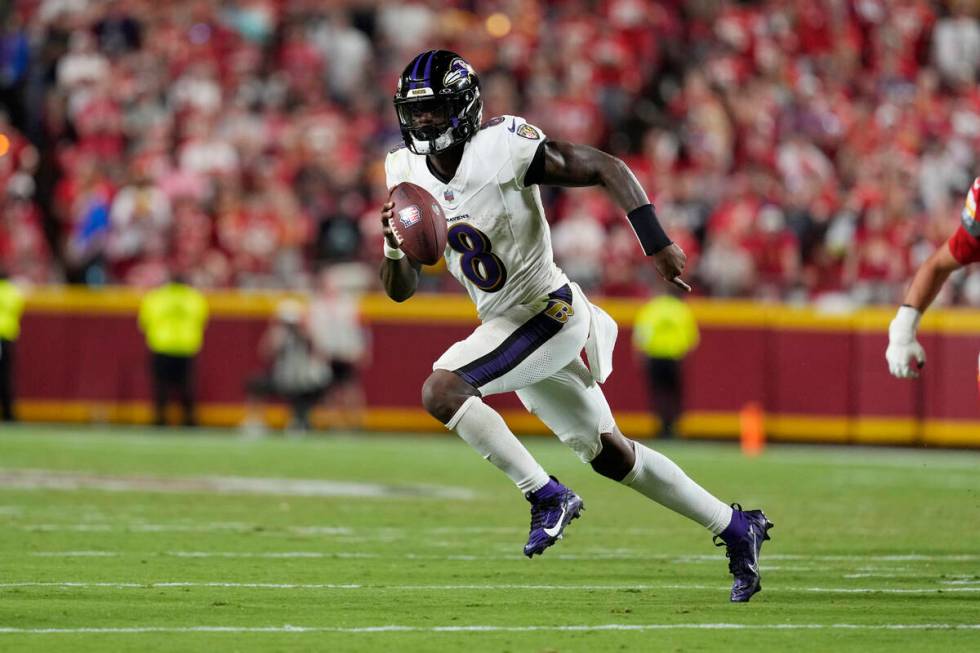 Baltimore Ravens quarterback Lamar Jackson runs against the Kansas City Chiefs during an NFL fo ...