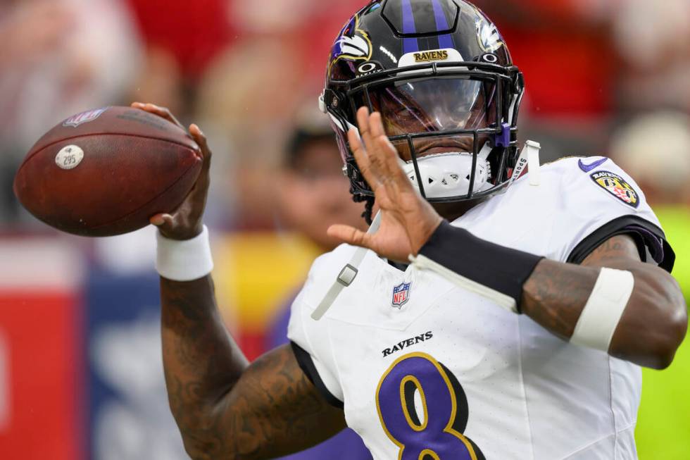 Baltimore Ravens quarterback Lamar Jackson throws during warmups before an NFL football game ag ...